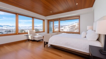 Fototapeta premium Modern bedroom with panoramic mountain views, featuring elegant furniture and natural light