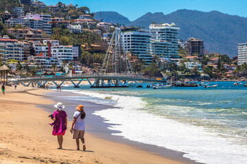 Two women walking along the seashore in Puerto Vallarta, Jalisco, Mexico