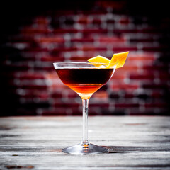 Red cocktail against brick background