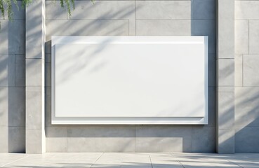 Blank billboard on light grey stone wall. Advertising space for display. Empty board for marketing promotion. Mockup for retail store. Urban exterior, building facade. Shadow of leaves on sunny day.