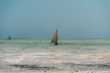 Traditional dhow sailing boats on the turquoise water of zanzibar, tanzania