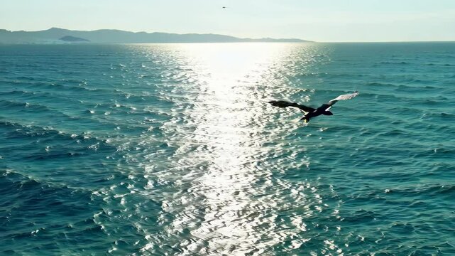 A surfer in action rides a powerful wave in the vast ocean under the summer sky