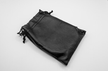 Sophisticated Pouch: An elevated view showcases a premium, sleek black leather pouch, expertly crafted and sealed with a drawstring closure, offering a luxurious touch.