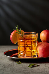 Apple juice and fresh apples on an old kitchen table.