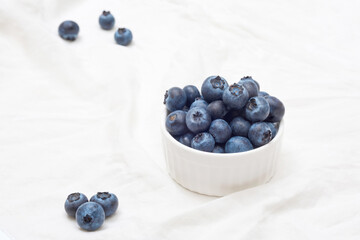 Fresh blueberries in bowl, on white background. Organic berries, healthy food, wild berries
