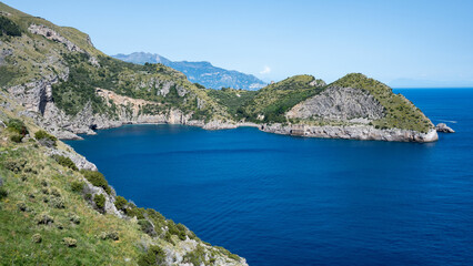 Ieranto Bay seen from afar from the promontory of Punta Campanella, on a sunny day with blue sea. Massa Lubrense.