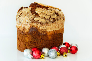 Panettone - traditional Christmas cake isolated on white background with colorful balls, delicious easter cake