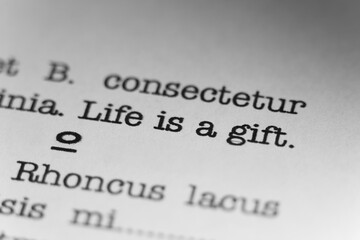 Life is a gift. Text printed on a page. A piece of paper with a phrase written in retro typewriter...