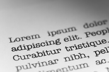 Lorem ipsum text printed on a page. A piece of paper with words written in retro typewriter font.