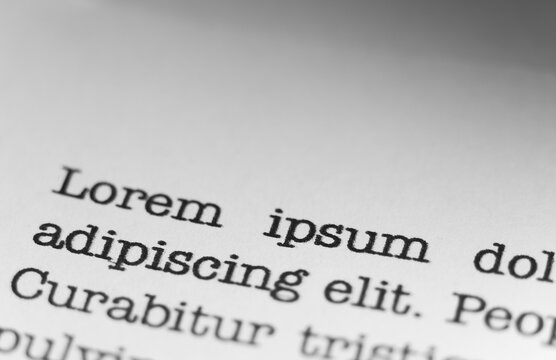 Lorem ipsum text printed on a page. A piece of paper with words written in retro typewriter font.