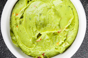 Guacamole dip avocado sauce appetizer vegetable dish organic product fresh tasty gourmet food background on the table rustic food top view copy space 