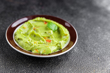 Guacamole dip avocado sauce appetizer vegetable dish organic product fresh tasty gourmet food background on the table rustic food top view copy space 