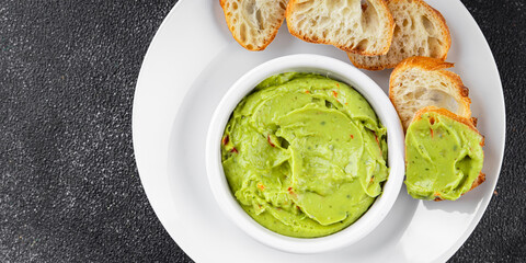 Guacamole dip avocado sauce appetizer vegetable dish organic product fresh tasty gourmet food background on the table rustic food top view copy space 