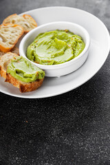 Guacamole dip avocado sauce appetizer vegetable dish organic product fresh tasty gourmet food background on the table rustic food top view copy space 