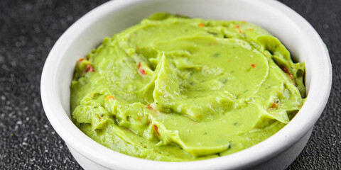 Guacamole dip avocado sauce appetizer vegetable dish organic product fresh tasty gourmet food background on the table rustic food top view copy space 