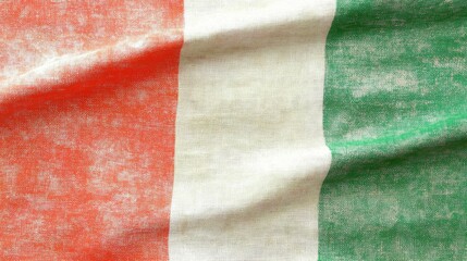 Close-up of a textured vertical striped textile with red, white and green hues featuring soft, diffused lighting, subtle creases and aged fabric details captured in high-resolution for