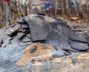 Pile of broken asphalt rubble at construction site.