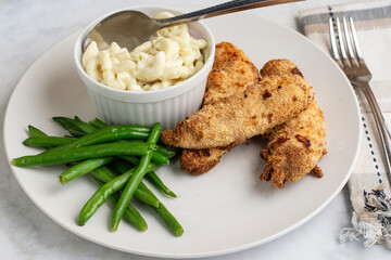 chicken  tenders with green beans and macaroni salad