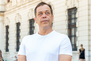 Urban portrait of an adult male in summer clothes.