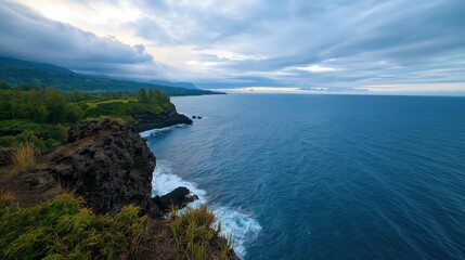 Landscape photograph of a beautiful view of the ocean. the sky is blue with white clouds scattered across it, and the horizon line is visible in the distance.