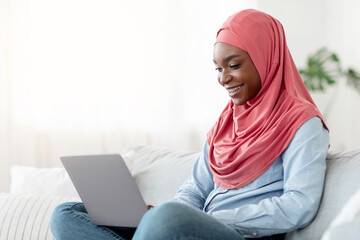 Internet Shopping. Young Black Muslim Lady In Hijab Buying Things Online With Laptop At Home,...
