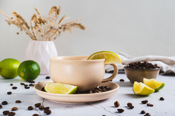 Cold coffee with lime wedges in a cup on the table