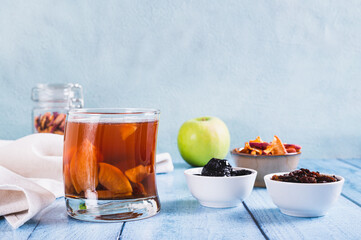 Traditional drink made from prunes, raisins and apples uzvar in a glass on the table
