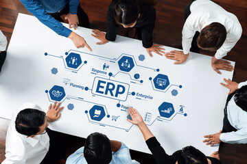 A diverse business team collaborates around a table, discussing ERP concepts and planning strategies in a modern office. Engaged professionals work on innovative solutions. Amity