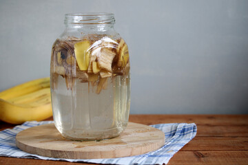 Gardener preparing natural banana peel fertilizer for houseplants