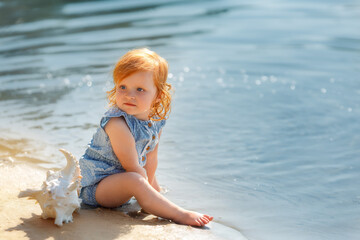 Little Red hair Girl Looking into the Distance by the Sea