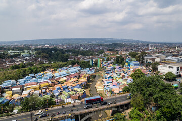 Jodipan colorful village, malang east java showing houses and bridges with traffic passing by
