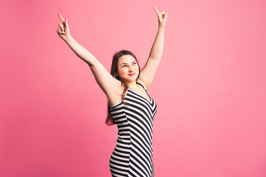 Happy pize size model in striped dress, fat woman on purple background