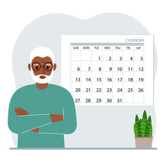A man plans his schedule, meetings for a month, holidays, weekends and important dates. Time management and optimization. Big calendar and a man.