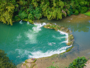 Loboc River with small waterfall and river threshold in Bohol island, Philippines. Aerial drone...