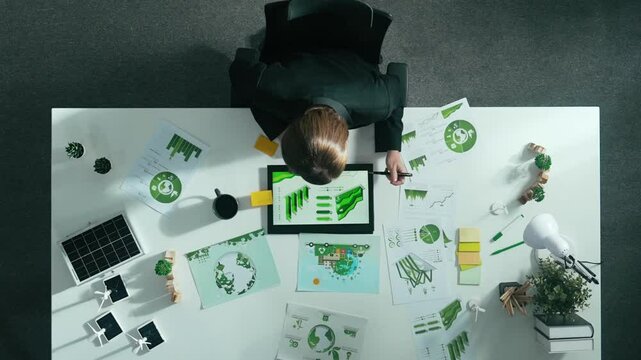 Time lapse of manager make decision about green business investment. Aerial view of professional business woman working at meeting table with document about green energy and zero waste. Alimentation.