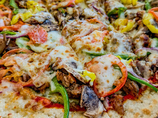 Colorful Red, Yellow, And Green Pizza With Melted Cheese