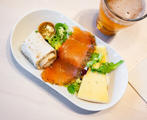 Swedish appetizer - salted salmon fillet, cheese, pitta bread and greens
