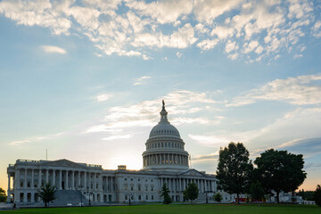 Capitol as a symbol of democracy in Washington, DC. The Capitol building on Capitol Hill. US government. American flag adorns the dome of the historic Capitol. The Senate. Capital of America.