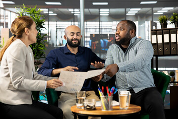 Angry employee in office destroying relationship with business partners, yelling at them, unhappy with work done. Upset manager berating shareholders, displeased by low investments