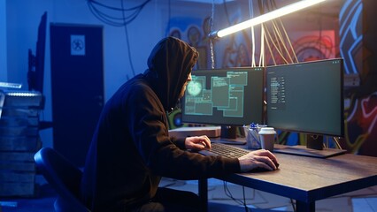 Hacker arriving in underground base, ready to do computer sabotage using encryption trojan ransomware. Cybercriminal starting hacking process, ransoming stolen data from victims, camera A