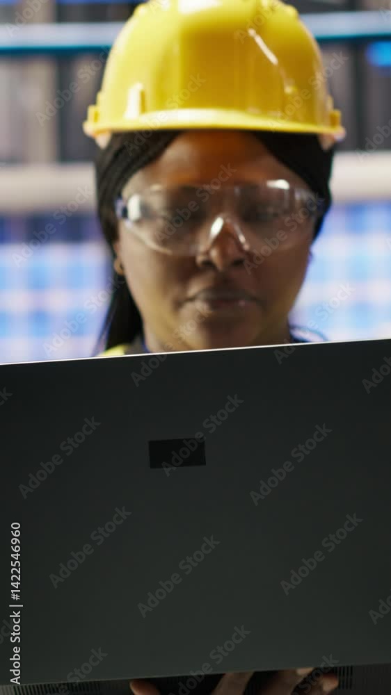Poster vertical video smart factory engineer using laptop to implement automated workflows and control syst