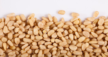 Pile of delicious pine nuts on a white surface. High quality photo