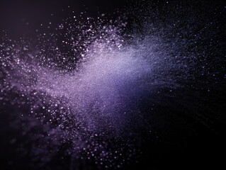 Obraz premium An abstract image featuring a burst of purple particles against a dark backdrop, resembling a cosmic explosion or a burst of energy.