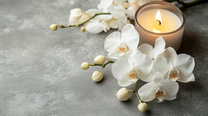White orchids and a candle on a gray background make a pretty home décor scene.  Plenty of space is available to show off your products.
