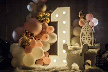 Charming photo zone for baby’s first birthday: pink balloons, illuminated number 