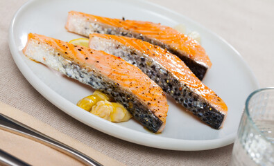 Plate of tasty fish dish - slices of roasted salmon with asparagus
