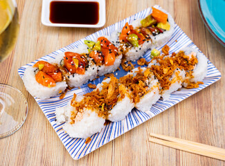 National dish of Japanese cuisine is Uramaki rolls and Saketaki rolls made from crabs, avocado, cucumbers and salmon with .sake-boiled salmon, avocado and fried onions