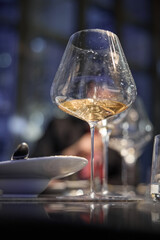 Champagne tasting, Wine glasses are on the table, stylish table setting, wine is poured from a bottle and decanter, sparkling wine bubbles, snacks, people smell the aroma and taste the wine