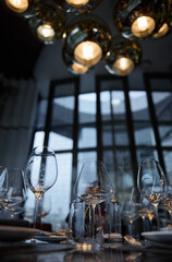 Champagne tasting, Wine glasses are on the table, stylish table setting, wine is poured from a bottle and decanter, sparkling wine bubbles, snacks, people smell the aroma and taste the wine