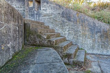 Weathered concrete steps lead to an abandoned gun emplacement at Cape Disappointment State Park,...